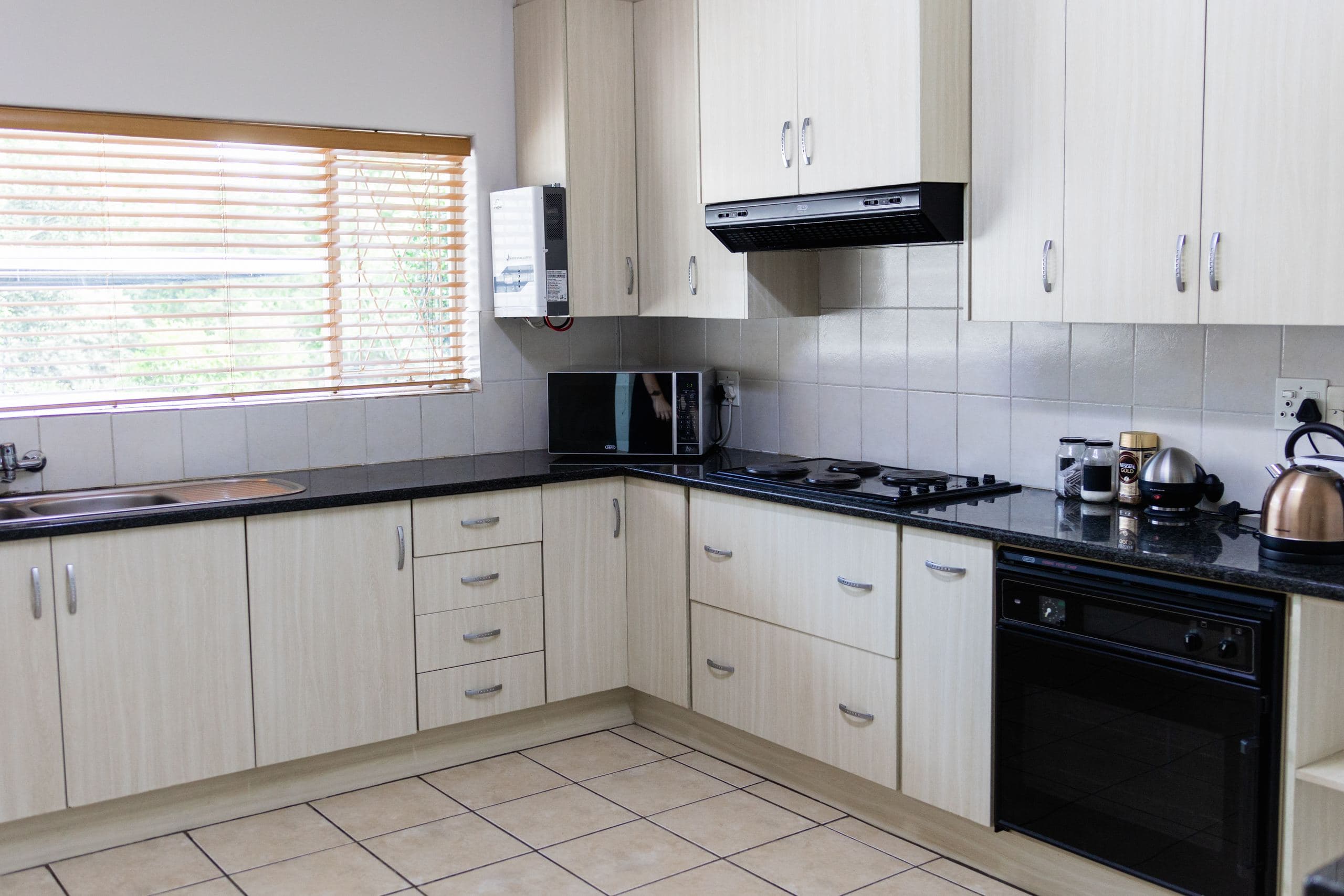 The school's kitchen, with a gas stove, extractor hood and microwave